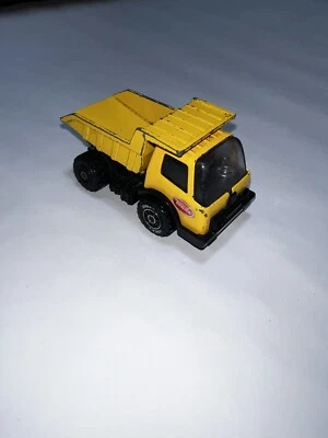 Tonka Pressed Steel Yellow Dump Truck w/ Tilt Bed Made in Japan 3 1/2 in L - Image 1 of 4