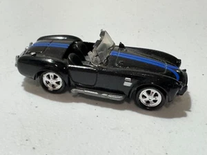 1965 65 SHELBY COBRA 427 SC BLACK W/ BLUE STRIPE 1:64 1999 Johnny Lightning - Picture 1 of 4