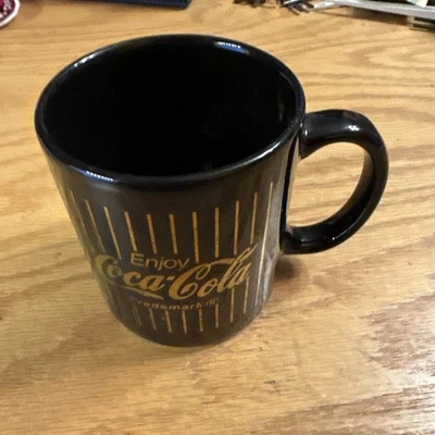 Taza de café Coca-Cola vintage negra y dorada Foto 1 de 4