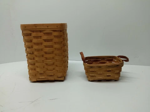 2 longaberger Basket hand woven one tall one small with leather handles on sides Cover