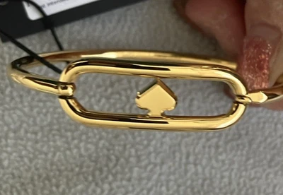 PULSERA KATE SPADE "CORTE A LA PERSECUCIÓN" (TONO DORADO) Foto 1 de 4