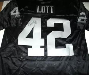 MAGLIA RONNIE LOTT OAKLAND RAIDERS,HOF CON LICENZA UFFICIALE FIRMATA CAA CHAMPION - Foto 1 di 2