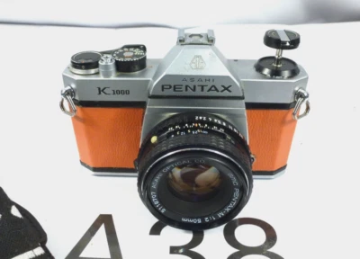 Asahi Pentax K1000 SLR with 50mm f/2 Lens Orange Covering refm - Image 1 of 4