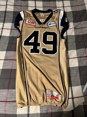 Camiseta deportiva Reebok Winnipeg Blue Bombers Chase Vaughn 2015 emitida talla 40 CFL dorada Foto 1 de 4