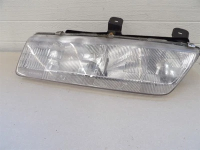 SATURN S SERIES 1991-1995 fixed composite LH HEADLIGHT ASSEMBLY W/ MOUNT BRACKET - Image 1 of 4