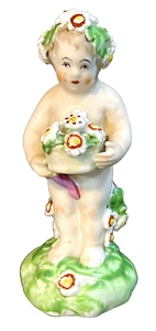 Eine Bogen Porzellan Figur eines Putto aus dem 18. Jahrhundert mit Blumen signiert - Bild 1 von 6
