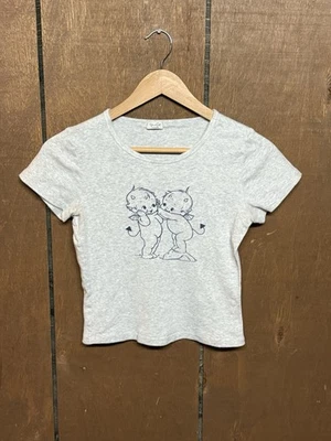 Camiseta Brandy Melville John Galt Angel Bebé Manga Corta Camiseta Talla Única Para Mujer’s Foto 1 de 4