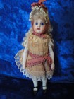 Antique doll mignonette doll closed mouth original dress similar to S & H 949