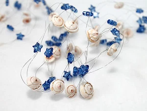 Tischdekoration mit Muscheln 90cm blau Sterne Drahtband Girlande - Bild 1 von 8