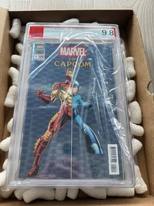 KITH MARVEL VS. CAPCOM #1 IRON MAN VS. MEGA MAN BLUE VARIENT IN HAND 9.8 PSA - Bild 1 von 2