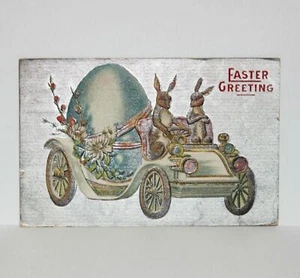 Postal antigua vintage de saludo de Pascua conejo conducir huevo coche animal de vacaciones - Imagen 1 de 2