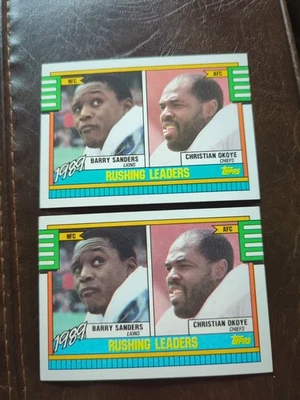 Two 1990 Topps - #28 Christian Okoye - Barry Sanders ‘89 NFL Rushing Leaders  - Image 1 of 4