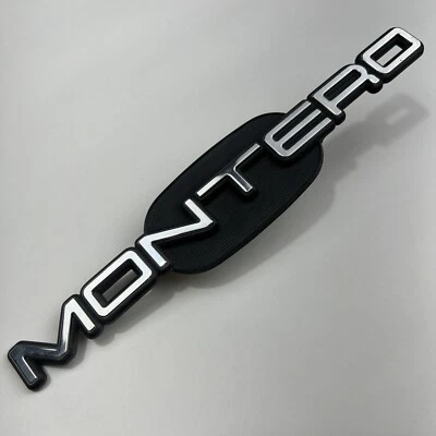 1998 1999 Mitsubishi Montero-“Montero” Fender emblema emblema logotipo original fabricante de equipamento original - Imagem 1 de 4