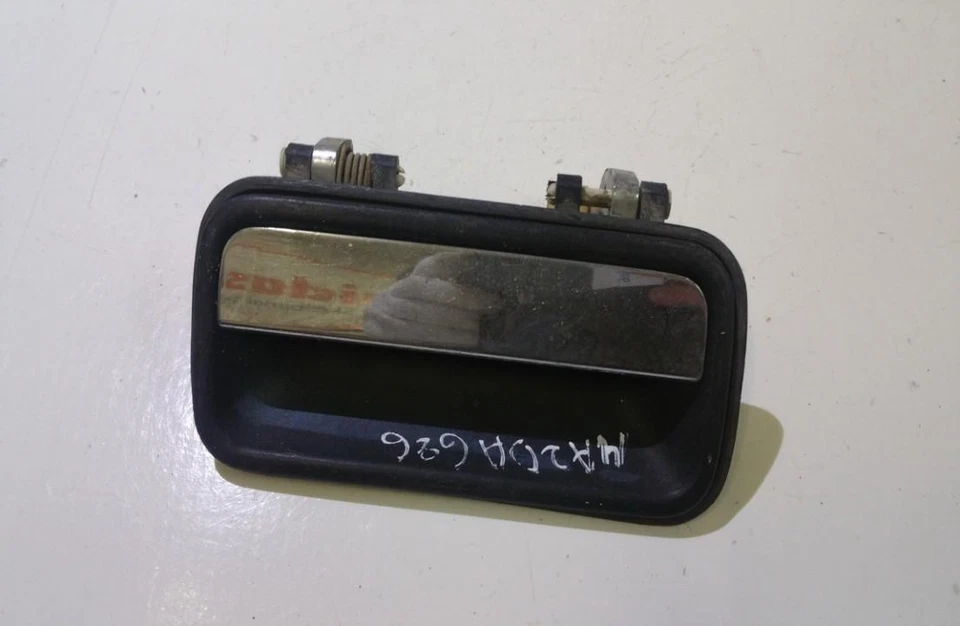 Manija de puerta exterior Mazda 626 1988, parte trasera izquierda usada, original #142911-41 Foto 1 de 1