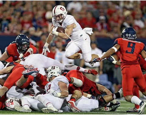 Christian McCaffrey Cardinals UnSigned Jersey Leaps Line vs Wildcats Photo Cover