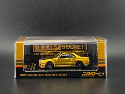 Inno64 Nissan GT-R R34 dorado Top Secret MDX EXPO 2024 Salón del Automóvil de Tokio 1/64 Foto 1 de 4