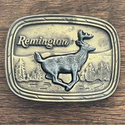 Hebilla de cinturón vintage Remington brazos logotipo correr ciervo cola blanca 1979 Sid Bell Foto 1 de 4