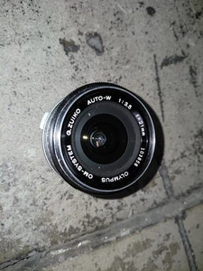 Olympus OM-System G.Zuiko Auto-W obiettivo 21 mm f/3,5 buono vetro trasparente senza tappo obiettivo - Foto 1 di 3