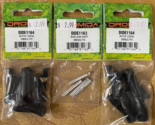 Dromida Ominus FPV Motor Covers DIDE1164 (2) & Main Gear Shafts DIDE1163; NISP - Image 1 of 1