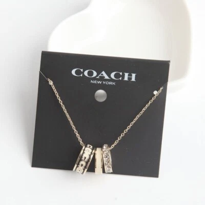 Collar esmaltado Coach Signature en dorado/negro con bolsa antipolvo Foto 1 de 4