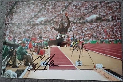 carl lewis jumps far to score high to win gold in final signed 12x8 photo - Image 1 of 4
