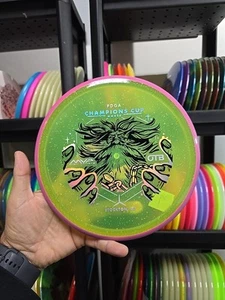 Axiom Discs Particle Proton Hex 177g #7 Disc Golf Champions Cup 2025 Mvp Glow - Picture 1 of 7