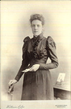 1890s cabinet photo studio portrait of a woman holding photo by Coles of Watford