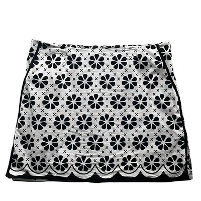 Falda corta deportiva de golf Golftini para mujer 8 negra blanca con estampado floral The Masters Foto 1 de 4