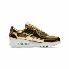 gold and black nike trainers