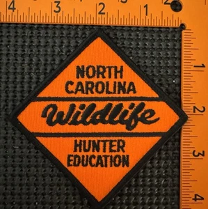 Parche de caza North Carolina Hunter Education vida silvestre bordado naranja negro - Imagen 1 de 2