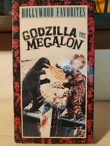 Hollywood Favorites - Godzilla Vs Megalon - VHS - Foto 1 di 2