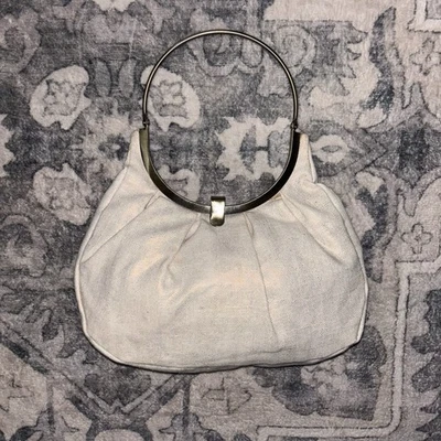Cream Colored Purse With Light Gold Shimmer and Metal Ring Handle/Snap Closure - Image 1 of 4