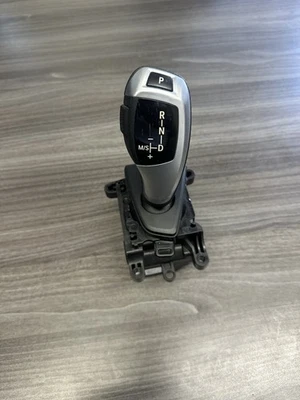 2012-2016 BMW 328i ПЕРЕКЛЮЧАТЕЛЬ ПЕРЕКЛЮЧАТЕЛЯ АВТОМАТИЧЕСКОЙ КОРОБКИ ПЕРЕДАЧ 10099971; 10049934 OEM - Изображение 1 из 4