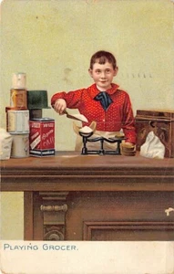Postkarte: Junge spielt Lebensmittelhändler, Tuck's, verschickt 1911 - Bild 1 von 2