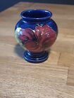 SMALL MOORCROFT HIBISCUS PATTERN FOOTED VASE.