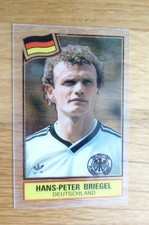 HANS-PETER BRIEGEL GERMANY BADGE ACETATE CARD PANINI FOOTBALL SUPERSTAR 1984 EX 