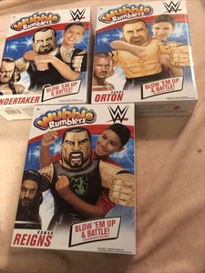 WWE WUBBLE RUMBLERS Roman Reigns Undertaker Randy Orton Inflatable Wrestlers NEW - Foto 1 di 8