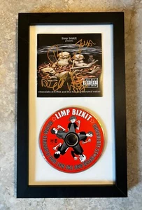 LIMP BIZKIT SCHOKOLADENSEESTERN UND DER HOT DOG AROMATISIERTES WASSER SIGNIERT GERAHMT CD - Bild 1 von 1