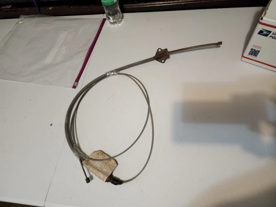 Pontiac GTO 1963-64 NOS GM de colección original cable de freno de estacionamiento pieza casi nueva # 9771225  Foto 1 de 4