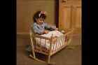 716030 Little Girl With Doll In Cradle A4 Photo Print