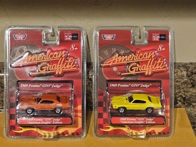 Motormax Lote de 2 1969 Pontiac GTO Judge '69 American Graffiti Naranja Amarillo Foto 1 de 4