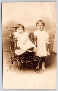 Two Young Children Girls Old Wicker Stroller Portrait RPPC Postcard Real Photo - Picture 1 of 2