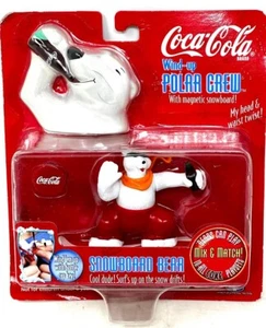 Coca Cola Aufzieh Polar Crew mit magnetischem Snowboard Kopf & Taille Twist Neu im Karton 1998 - Bild 1 von 2