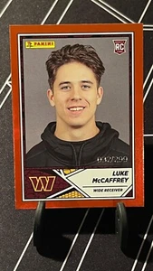 Panini NFL 2024 - Luke McCaffrey #99 DEOKIE - 032/299 CZERWONY numerowany - Zdjęcie 1 z 2