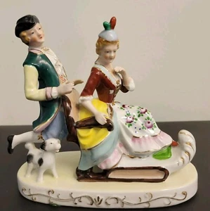 Vintage Occupied Japan Porcelain Figurine Man Pushing Woman on a Sleigh, Stamped - Picture 1 of 5