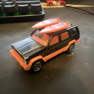 Majorette No. 224 Jeep Cherokee 1:60 Scale Black w/ Pink Surfboards SUV Loose - Picture 1 of 3