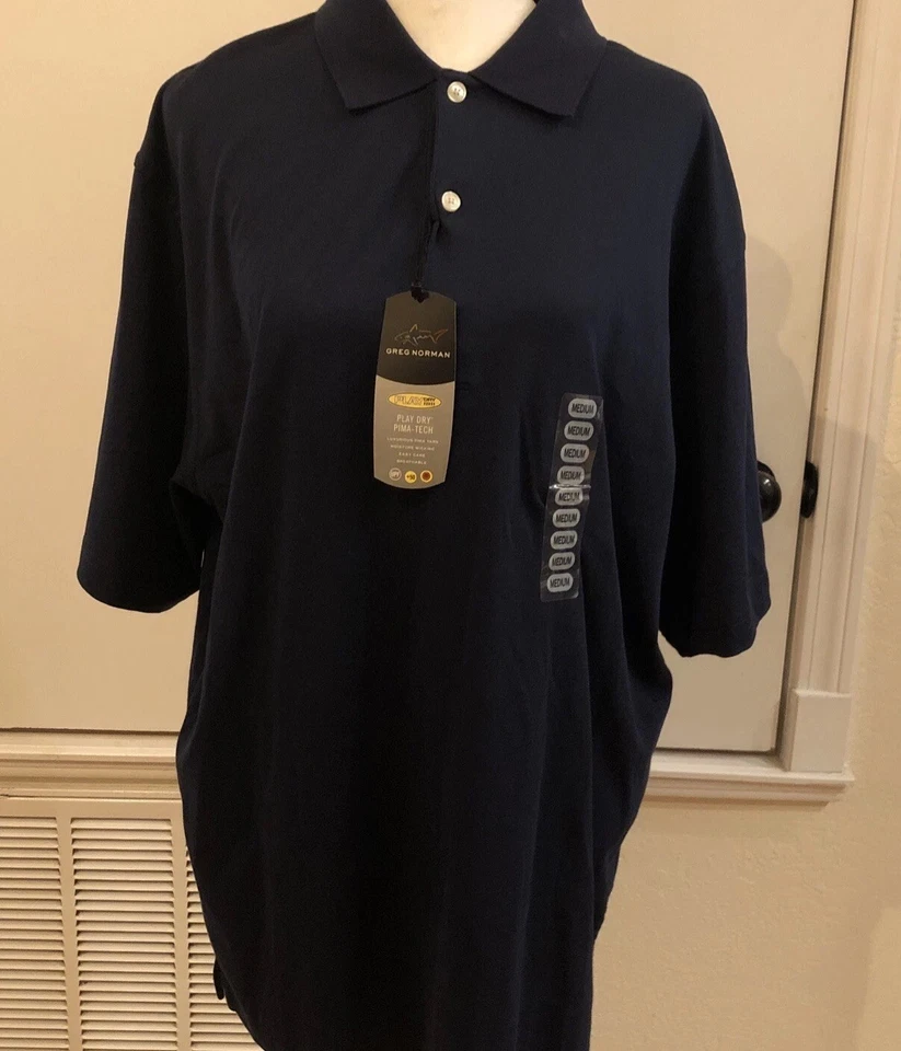 Nuevo con etiquetas Polo de golf Greg Norman azul marino para hombre Play Dry Pima-Tech talla mediana tiburón Foto 1 de 4