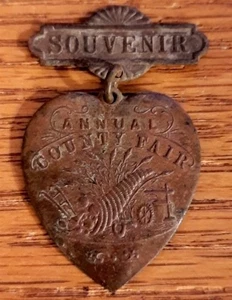 ANTIQUE SOUVENIR PIN COUNTY FAIR PINBACK HEART PENDANT CORNUCOPIA FARM EQUIPMENT - Picture 1 of 2