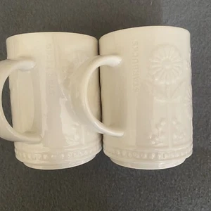 Pair Of Starbucks 3D Raised Daisy 12 oz Off White Cream Ivory Coffee Tea Mugs - Picture 1 of 7