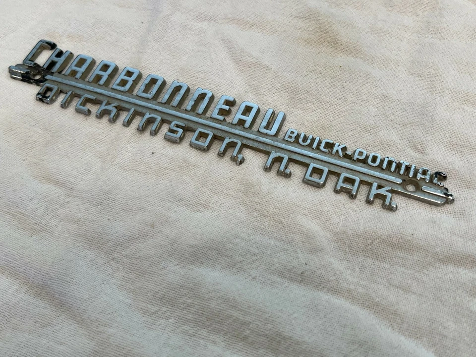 Charbonneau Buick Pontiac Metal Dealer Tag Dickinson, North Dakota Trunk Emblem  - Image 1 of 4